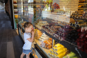 Child and Showcase oriental sweets,Turkish delight
