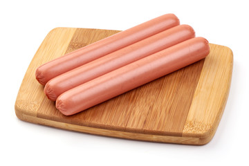 Fresh pork hot dog sausages on a cutting board, for barbeque or grill, close-up, isolated on white background