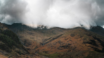 Storm clouds on a mountainside covering the peak in the Lake district, England