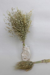 An amulet of dolls holding an angel from hay and a dry flower of handmade. Dry shoots, wheat, rye....