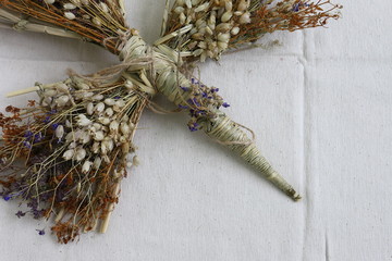 An amulet of dolls holding an angel from hay and a dry flower of handmade. Dry shoots, wheat, rye....