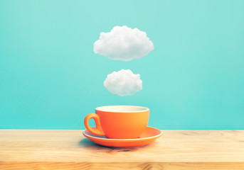 Inspiration creativity concepts with a cup of coffee on wood bar table with some cloud on blue sky...