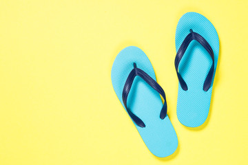 Blue flip flops on yelow. 