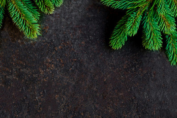 Christmas  background with fir branches on black stone  board with copyspace
