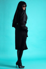 Femme trench et solaire en studio 