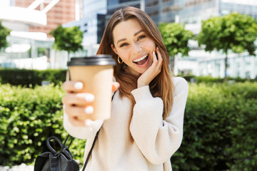 Beautiful young cheerful girl walking outdoors