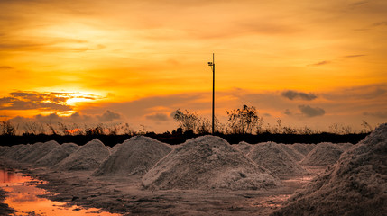 Salt farm in the morning with sunrise sky. Organic sea salt. Evaporation and crystallization of sea...