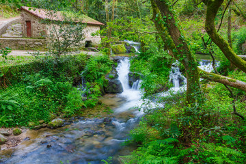 Fototapeta na wymiar Watermill and waterfall