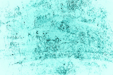 Vintage azure background. Rough painted wall of turquoise color. Imperfect plane of cyan colored. Uneven old decorative toned backdrop of aqzure tint. Texture of teal hue. Ornamental stony surface.