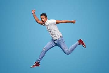 Shocked black man leaping and looking at camera