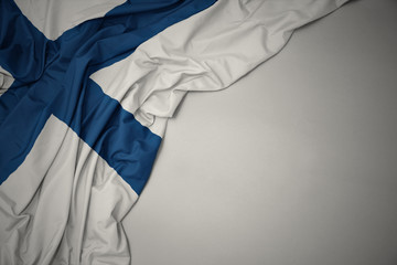 waving national flag of finland on a gray background.