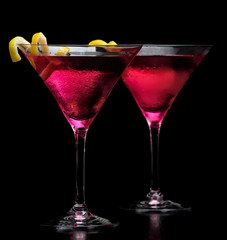 Pink cosmopolitan drinks isolated on black