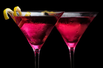 Closeup cosmopolitan drinks isolated on black