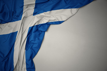 waving national flag of scotland on a gray background.