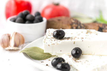 Greek feta cheese with olives and spices,