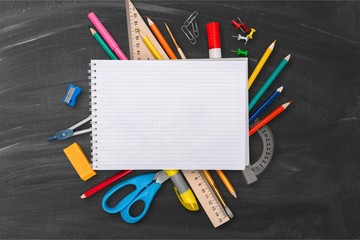 The assortment of School colorful  supplies on  background