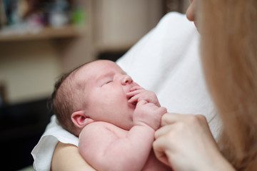 newborn baby girl on mom's hands