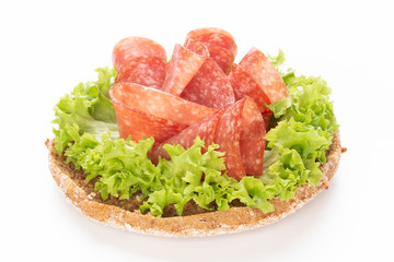 Sandwich with salami sausage on white background.