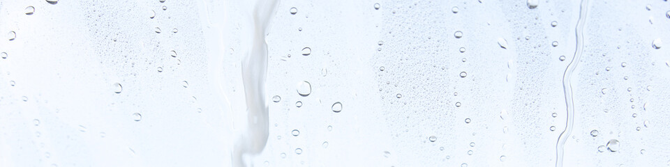 Fensterscheibe mit abperlendem Wasser als Hintergrund