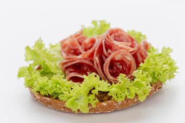 Sandwich with salami sausage on white background.