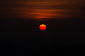 Abstract composition of the sun at sunset and Windmill in front of the sun