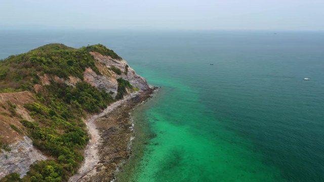 Aerial view of ocean waves, beach and rocky coastline and beautiful forest of Koh Larn, Pattaya, Thailand . Beautiful nature background.