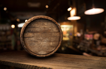 Beer barrel with beer glasses on a wooden table. The dark brown background.