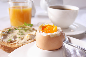 Brakfast table with soft boiled egg. Selective focus