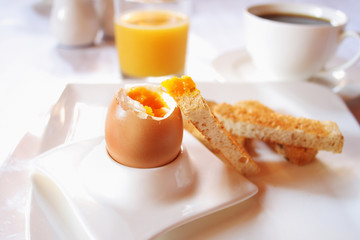 Brakfast table with soft boiled egg. Selective focus