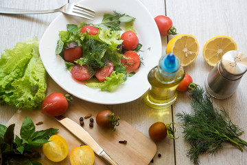 Vegetable salad with fresh lettuce, tomatoes and cucumber in clay pot. Top view.