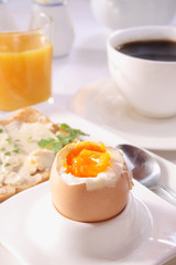 Brakfast table with soft boiled egg. Selective focus