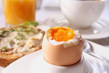 Brakfast table with soft boiled egg. Selective focus