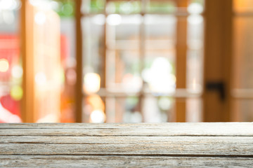 Empty of wood table top on blur of curtain with window view green from tree garden background.For montage product display or design key visual layout