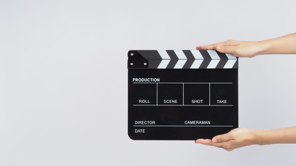 Hands is holding black Clapperboard or movie slate. it use in video production ,film, cinema...