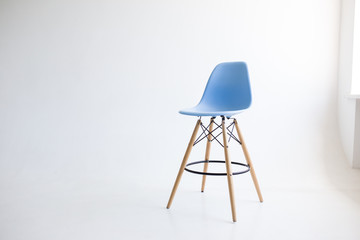 Blue wooden chairs for the legs on a white background. White cyclorama in the studio. Isolated.