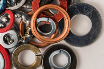 Divers industrial washers and rings. Various colorful washers rings on white background Screw washer