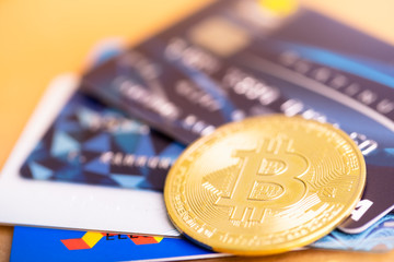 Bitcoin golden coin and VISA credit cards. virtual cryptocurrency concept. buy and sell bitcoin by credit card.