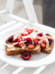 French toast with berries and mascarpone cheese on a light background.