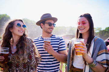 Three the best friends drinking beer outdoors .