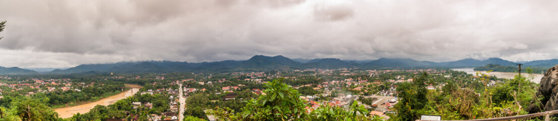Fototapeta na wymiar Panorama of the city of Luang Prabang in Laos, with the Mekong River, cloudy day with many clouds