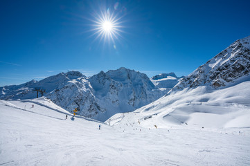 Austria, panorama of Mountain Range, winter Landscape with blue sky, sunshine and skiing slopes