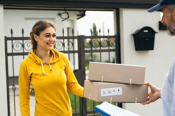 woman receiving a packages from post express courier