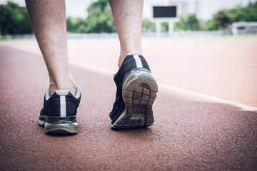 Fototapeta na wymiar Runner feet of athlete running on road track, exercise jog workout wellness concept