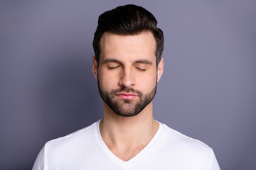 Obraz premium Close up photo amazing he him his macho perfect ideal appearance bristle easy-going person eyes closed calm not talk tell speak say smile refreshment wear casual white t-shirt isolated grey background
