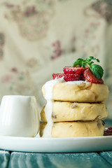 Close up. Rustic breakfast. Cheese pancakes with cream and strawberry. Copy space.