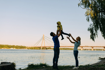 Parents play in the park with their son