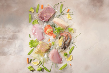 Sous Vide cooking concept. Vacuum packed ingredients arranged on light background. Top View.