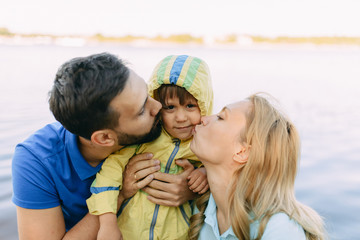 Parents play in the park with their son