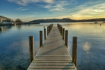 A view of a jetty on Windermere at sunset.