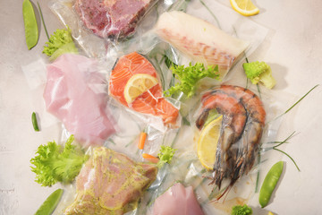 Sous Vide cooking concept. Vacuum packed ingredients arranged on light background. Top View.